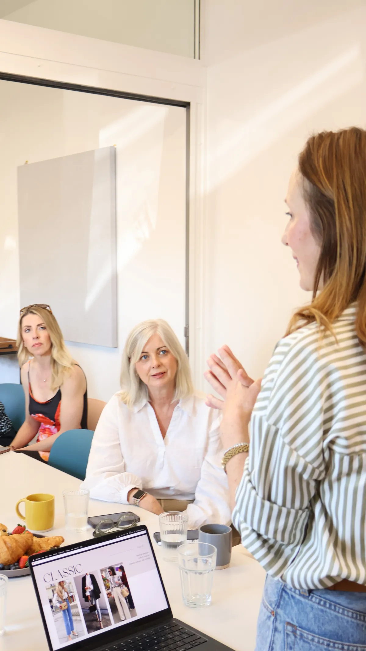 Julia teaching personal styling to students around a classroom table